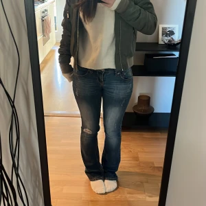 Lågmidjade jeans - Jätte snygga blåa lågmidjade jeans med knappar på fickorna nästan helt nya!  Skriv för mer bilder eller prisdiskution!