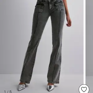 Gråa, lågmidjade bootcut jeans i strl 40, men skulle säga att dom är strl 38! De är från Nelly och är i toppen skick! (Knappt använda) Skriv för fler bilder eller frågor!❤️Nypris:700kr