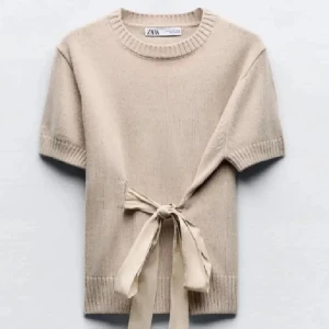 Beige stickad tröja från Zara - Säljer en stilren beige stickad tröja från Zara med korta ärmar och en dekorativ knytning i midjan. Perfekt för en avslappnad men chic look. Passar bra till både jeans och kjol. Väldigt trendig tröja❤️❤️ändrar priset om bud uppkommer så priset som står är budet just då❤️