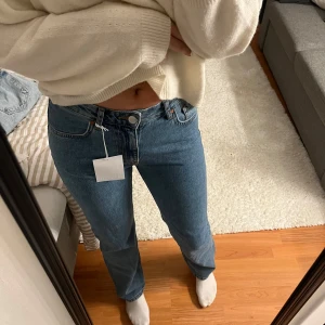Nya Lågmidjade jeans  - Helt nya lowwaist jeans från Bikbok i rakpassform i en as snygg blå färg, W 27 L32 som motsvarar ca 36-38!
