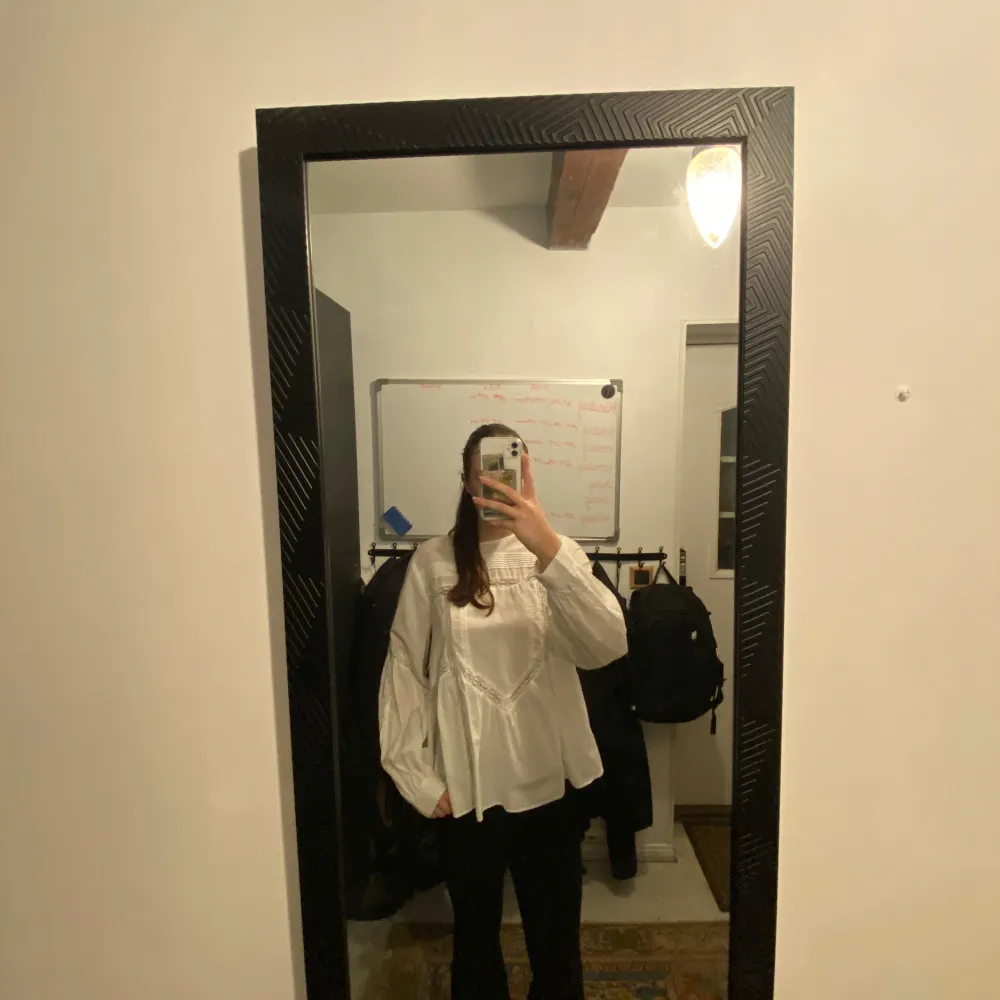 Säljer en elegant vit blus med volangdetaljer och långa ärmar. Perfekt för en stilren look. Blusen har en lös passform och knappar framtill.. Puserot.