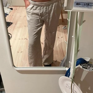 Beige linnebyxor från 157 - Säljer ett par bekväma beige linnebyxor från 157 i storlek XS. Byxorna har en avslappnad passform med resår i midjan för extra komfort. Perfekta för en ledig stil.