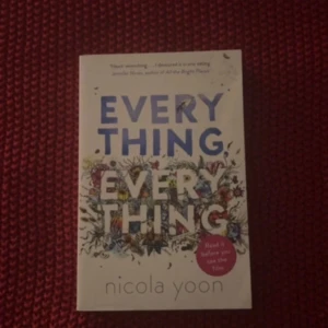 Everything, Everything - Boken 'Everything, Everything' av Nicola Yoon handlar om en tjej som lever isolerat på grund av en sjukdom. Omslaget är vitt med titeln i stora blå och svarta bokstäver, dekorerat med blommor och växter. En röd cirkel på framsidan nämner att boken har filmatiserats.