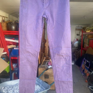 Lila byxor från Uniq - Säljer ett par snygga lila byxor från Uniq. De har en straight passform och är perfekta för både vardag och fest. Byxorna är i bomull och har en klassisk design med fickor både fram och bak. Perfekta för att ge din outfit en färgklick!