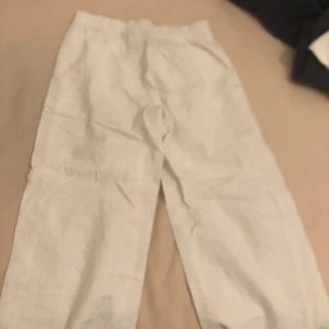 Vita linnebyxor från Kappahl - Säljer ett par vita linnebyxor från Kappahl. Byxorna har en avslappnad passform och är perfekta för varma dagar. De har en elastisk midja för extra komfort.