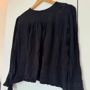 Svart blus från NAKD - Svart blus med svarta spetsdetaljer. Nyskick. Strl 36 (S)