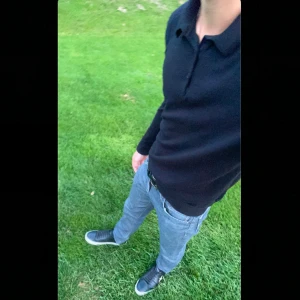 Svart kashmir-blend pikétröja - Säljer en stilren svart pikétröja från H&M i slim fit. Tröjan har långa ärmar och en klassisk krage med knappar framtill. Perfekt för en snygg och avslappnad look. Skriv vid minsta funderingar😊