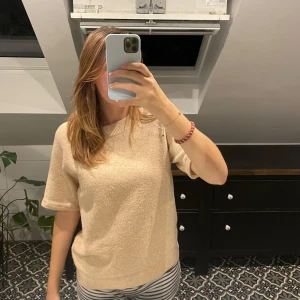 Stickad T-shirt  - Aprikosfärgad Stickad T-shirt som jag har klippt av och sytt om ärmarna på💓använd kanske 4 gånger och den är från vero Moda💓