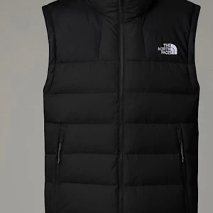 Svart dunväst från The North Face - Säljer en stilren svart dunväst från The North Face. Västen har en dragkedja framtill och två praktiska sidofickor med dragkedja. Perfekt för kyligare dagar och ger en sportig look.