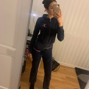 Mörkblått velourset från Juicy Couture (kofta och byxor ingår) - Säljer ett mörkblått vintage mjukisset från juicy couture. Den är i bra skick då jag tycker att den bra kvaliteten har hållit i sig efter många år. Detta setet är ganska flitigt använt därför är resåren förmodligen inte lika bra som innan, men dom funkar ändå +man kan även knyta byxorna. Kontakta mig privat om ni endast vill köpa ena plagget, då löser vi det!