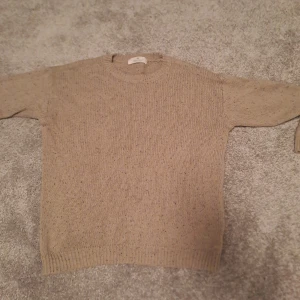 Beige stickad tröja från H&M - Säljer en mysig beige stickad tröja från H&M. Perfekt för kyliga dagar med sin varma och bekväma passform. Tröjan har långa ärmar och ribbade muddar vid ärmslut och nederkant. Passar både till vardags och lite finare tillfällen. 🧶✨