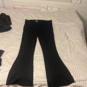 Svarta bootcut byxor - Säljer ett par svarta bootcut byxor i mycket bra skick. De är högmidjade och har en snygg passform som passar perfekt till både vardag och fest. Materialet är mjukt och stretchigt, vilket gör dem superbekväma att ha på sig. Perfekta för höst och vår!