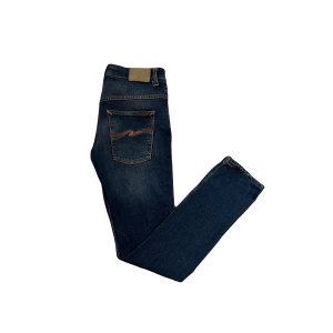 Nudie jeans - Nudie jeans med snygg wash. Modell tape ted. Storlek 31/34.
