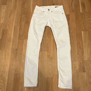 Vita skinny/slim jeans från dondup - Snygga vita skinny jeans från George med en stilren design. Byxorna har en smal passform och är tillverkade i ett bekvämt material. Perfekta för en trendig look och har små sluttningar runt om fickorna.passar för dem som är 160-172,pris ej hugget i sten!!