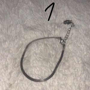 Tre stilrena armband i olika stilar - Säljer tre armband: 1. Ett enkelt silverfärgat armband med justerbar kedja. 2. Ett glittrigt silverarmband med små detaljer och justerbar kedja. 3. Ett beige snörearmband med en liten silverfärgad dekoration i mitten. Perfekta för att mixa och matcha till olika outfits! Privat för pris 