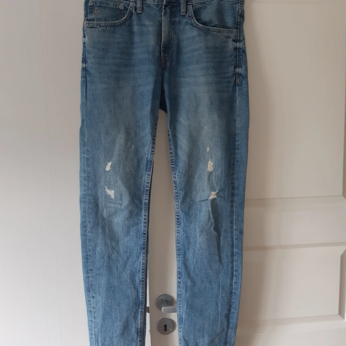 Blå jeans med slitningar