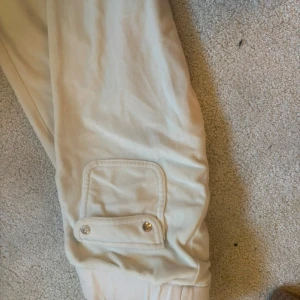 Beige mjukisbyxor från Juicy Couture - Säljer ett par bekväma vita mjukisbyxor från Juicy Couture. Dessa har jag andvänt många gånger, därav det låga priset då det finns några små små fläckar.