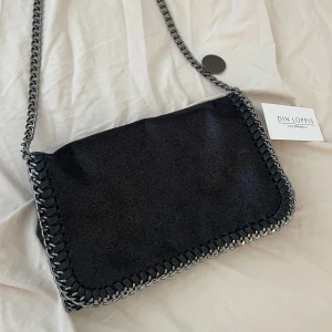 Stella liknande väska - Super fin axelremsväska med kedjeband. I nyskick, inga tecken på användning. Köpte den på loppis så vet inte vart den är ifrån ursprungligen. Jätte fin väska perfekt till hösten och har mycket plats. Storlek referens bild finns privat 