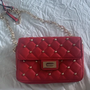 En röd Ginatricot väska med nitar - En röd jätte fin väska utan några skador eller fläckar säljer pgr av att jag aldrig har använt den har aldrig haft tid❤️❤️