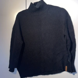 Svart stickad tjocktröja  - Svart stickad tröja. Lite polokrage