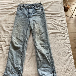 Blåa långa jeans - Från H&M. Ett par långa jeans. Högmidjade och har massor av knappar istället för en gylf. En slits längst ner på benen. Lite tajtare upptil. Frakten som står gills INTE utan diskuteras privat istället!