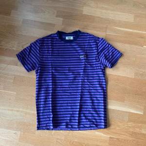 Tommy Hilfiger purple striped T-shirt  Pris: 79kr   Storlek M   Modellen är 179cm och väger 84, har vanligtvis M i tröjor och 33/33 i byxor
