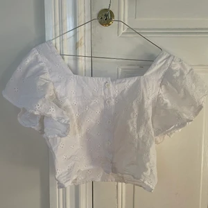 Vit topp size S  - Säljer denna supergulliga vita toppen med gulligt mönster som både passar till stranden eller middagar💖 Jag köpte den på second hand för ett tag sen, men säljer då den inte riktigt är min stil längre💕 Den är storlek S men skulle även säga att den passar en M då den är stor i modellen. Vill bli av med snabbt så först till kvarn gäller!🥰 (Vet inte vad frakten kommer att kosta än) 