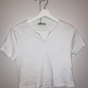 Magtröja  - En basic vit magtröja med en lite öppning. Den är jätte söt tvyärr blir den förkort på mig 