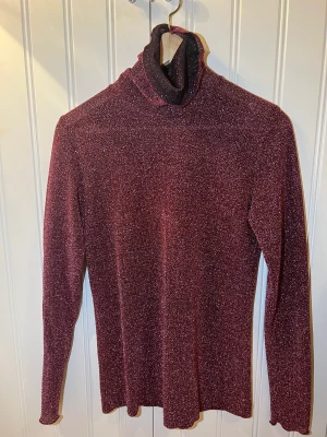 Julie Fagerholt polotröja - Julie Fagerholt polotröja i glitter.  I bra skick.  Storlek XS, passar även S.   Kund står för frakt.