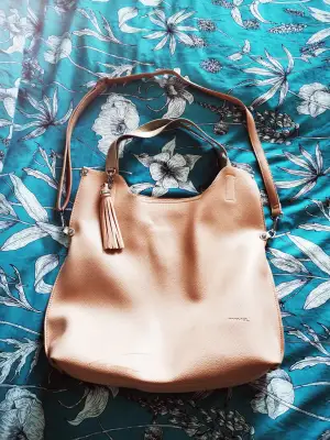 Big nice pink/apricot bag. It has a small mark in the down part but it is almost imperceptible. As well, the zipper inside is a little bit unstitched but it is very easy to fix. Feel free to ask for more pics :) 