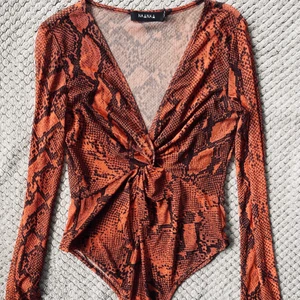 Ormmönstrad body mesh - Använd en gång. Storlek 38/medium skulle jag säga. Knäpps med knapp mellan benen. 