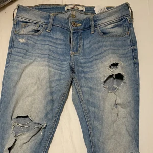 Lågmidjade low waist jeans från Hollister med hål - Säljer dessa lågmidjade jeans från Hollister i storlek midja 25, längd 29. Perfekt på mig som är 1.67. Säljer för 200:-