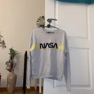 Grå sweatshirt ”NASA” från H&M. Storlek M. Använd några gånger, men fortfarande i bra skick. Kommer ej till användning längre. Köparen står för frakten! 