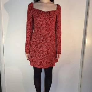 röd klänning med leopardmönster från H&M - jättefin röd klänning med leoparmösnter från H&M i storlek 36. färgen är som på sista bilden. möter ej upp, postar enbart 🌸