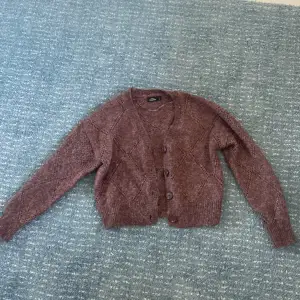 This is really warm and is very “furry”. It has been wore a few times. Goes with almost any outfit 