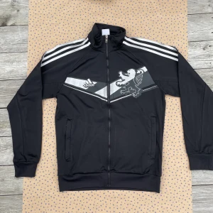 Olympique Lyon Track Top Svart Adidas - Olympique Lyon, franskt lag med historiska spelare som tidigare spelat för laget, däribland Benzema som vann Ballon d’Or här om dagen. Träningstoppen är i bra skick (8/10). Storlek Small men passar även som en mindre medium👌🏻👌🏻