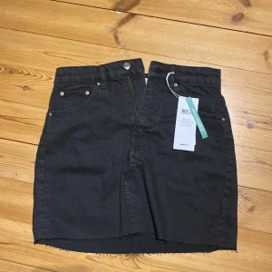 Svart Gina tricot jeanskjol  - Svart gina tricot jeansskjol i storlek 36, lappen är fottfarande på så har aldrig använts originalpris 300.