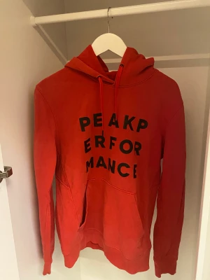 Röd hoodie - Röd hoodie från Peak Performance. Knappt använd. Storlek M