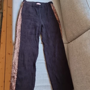 Festbyxor svarta - Sköna vida byxor med spetsdetalj på sidorna, snygga både för vardag och fest. Unikt material/modell. Stl S men kanske passar en liten M också! 🖤🩷 Bra skick 