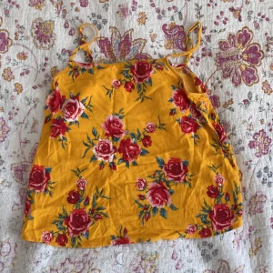 Linne - Ett orange linne med blommönster.