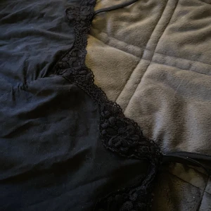 Svart,kort klänning - En kort klänning med spets vid bysten. Super gullig🧚🏽‍♀️ funkar även som ett längre linne. 92% bomull