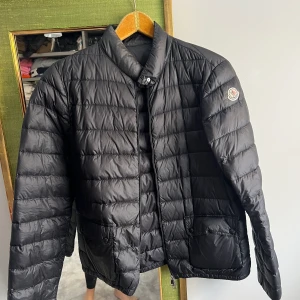 Mocler tunn dunjacka - Modell: Lans Giubbotto i stlk M (3)  (Moncler är mindre i storleken så passar även S skulle jag säga) Använd men fint skick. Nypris - 8000kr  Kan gå ner i pris vid snabb affär. Dragkedja bytt till svart. 