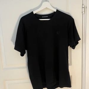 Acne T-shirt - En extremt mörk t-shirt från märket acne. Den är skit snygg och använd en del. Dock passar den inte längre så vill bli av med den. 2500kr ny pris. Storlek M men passar S. Köpt från butik i Malmö.