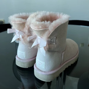 Rosa Uggs - Rosa Uggs men små rosetter på baksidan!  Fortfarande fluffiga inuti, strl 36