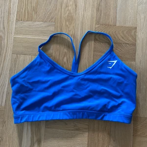Gymshark sportbh - Blå sporttop från Gymshark, storlek XL. Passar typ en D-F kupa. Kan fraktas mot kostnad eller mötas upp i Uppsala. 