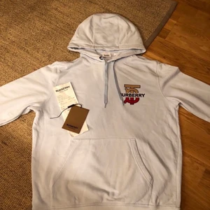 Burberry tröja - Säljer min babyblåa Burberry Hoodie. Tröjan har kvitto och tags kvar. Tröjan är varsamt använd men vid en tvätt gick det snett och fick en lätt missfärgning på ryggen men det är inget som syns tydligt Köpt för 5600kr. 