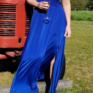 Blå klänning för fest och bröllop - Öppen i sidorna av midjan, slits vid benet, silkesmaterial. Dragkedja i rygg. Passar både medium och large
