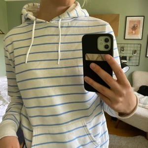 Blå-vitrandig hoodie - Hoodien är måttligt använd och i okej skick. Storlek L men passar mig som vanligtvis är M