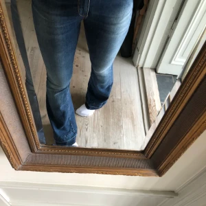 Lågmidjade Bootcut Jeans Twinset - Lågmidjade bootcutjeans köppta second hand men som inte längre kommer till användning. Storlek 28, jag är 168 och jeansen är långa för mig. I gott skick och med snygga hjärtdetaljer! 