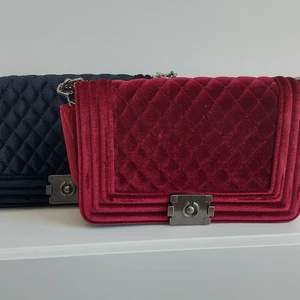 Röd väska i sammet  - Röd väska i sammet. Väskan har ett fack med dragkedja samt 2 öppna fack. Finns öven i svart( se tidigare annons). Priset är exklusive fraktavgift.